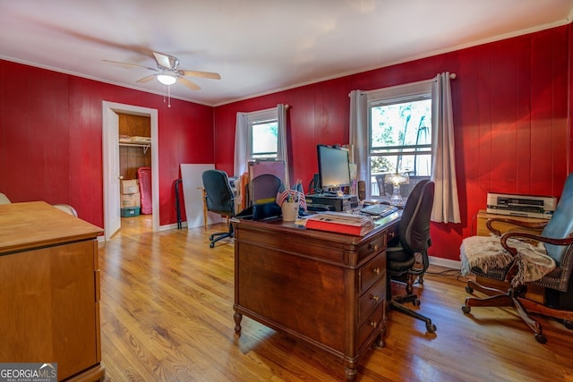 home office with light hardwood / wood-style floors, ceiling fan, and a healthy amount of sunlight