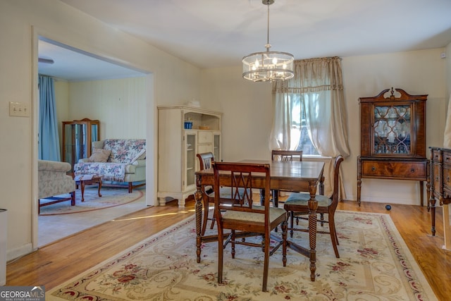 dining room featuring light hardwood / wood-style flooring and a notable chandelier