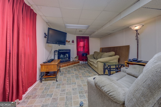 living room with a paneled ceiling