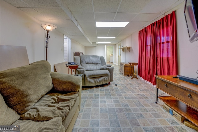 living room featuring a drop ceiling