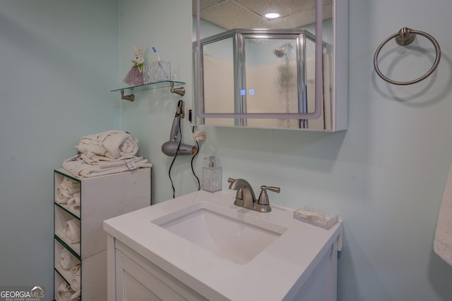 bathroom with vanity and a shower with shower door