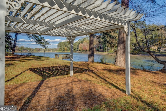 view of yard featuring a pergola and a water view