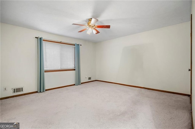 unfurnished room featuring ceiling fan and light colored carpet