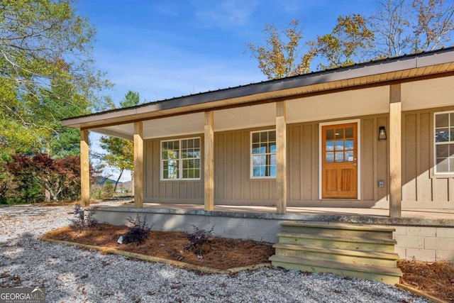 doorway to property featuring covered porch