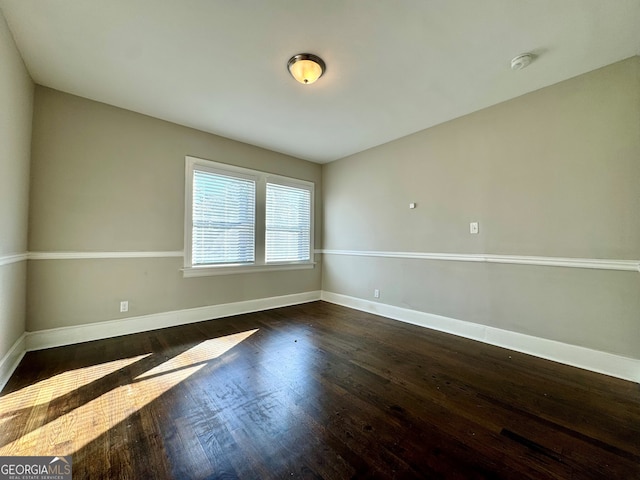 unfurnished room featuring dark wood-type flooring