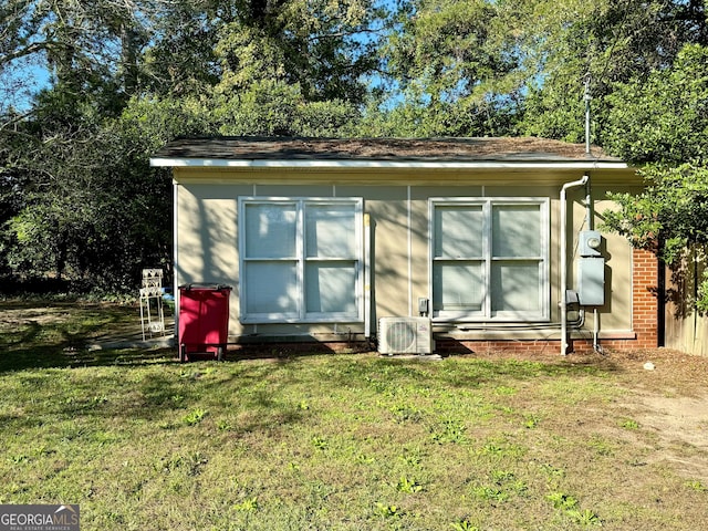 exterior space featuring a lawn and ac unit