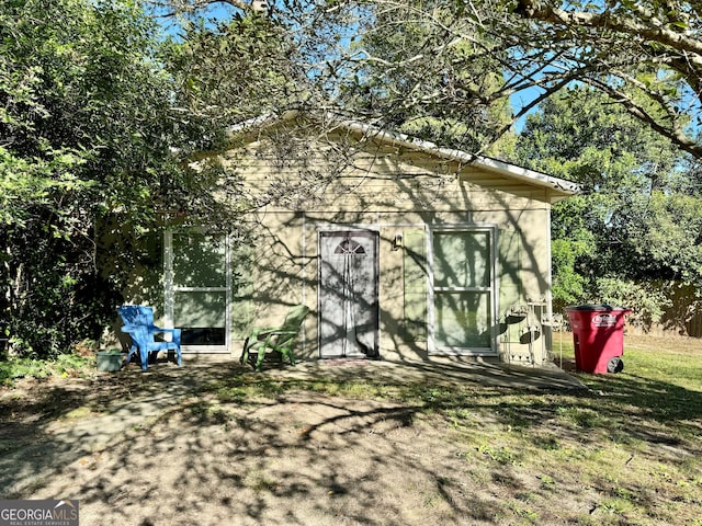 back of property featuring a shed