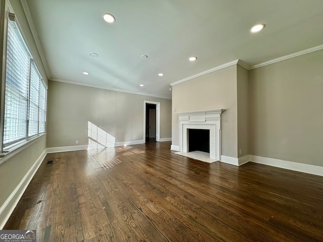 unfurnished living room featuring dark hardwood / wood-style floors, ornamental molding, and a fireplace