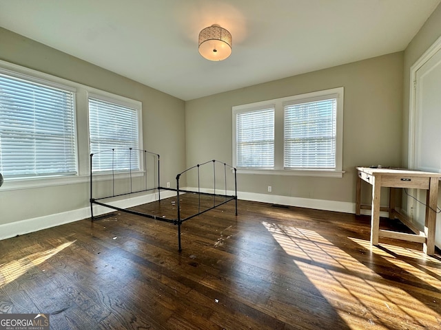 unfurnished bedroom featuring dark hardwood / wood-style flooring