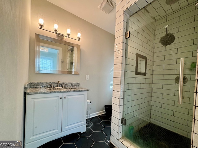 bathroom featuring tile patterned floors, vanity, and an enclosed shower