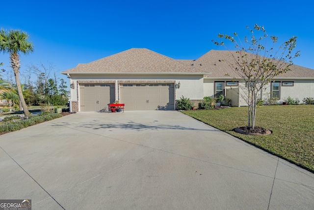 single story home featuring a garage and a front yard