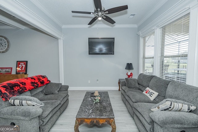 living room featuring ceiling fan, light hardwood / wood-style floors, and ornamental molding