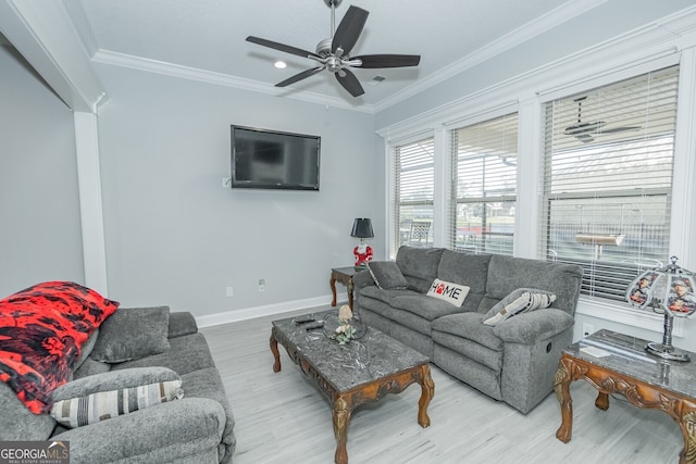 living room featuring hardwood / wood-style floors, ceiling fan, and crown molding