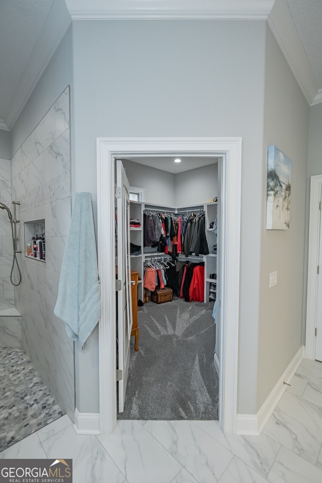 interior space featuring tiled shower and ornamental molding