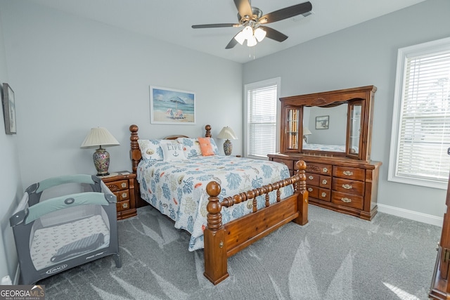 bedroom with carpet floors, multiple windows, and ceiling fan