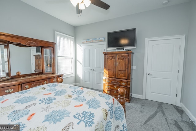 bedroom featuring ceiling fan and light carpet