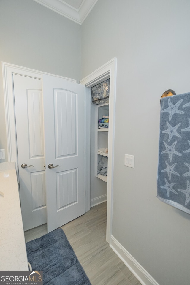 interior space with light hardwood / wood-style floors and ornamental molding