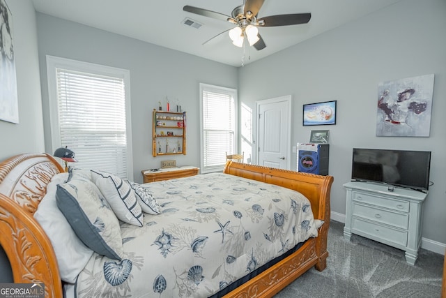 bedroom with ceiling fan and dark carpet