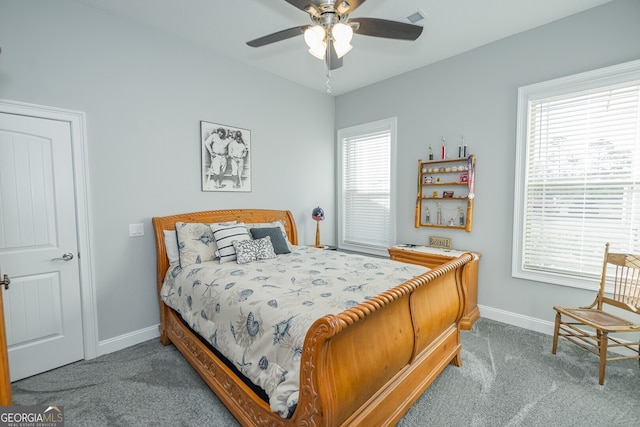 carpeted bedroom featuring ceiling fan and multiple windows