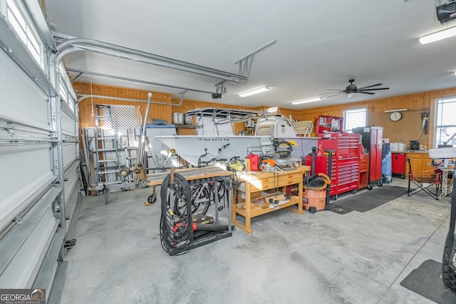 garage with a workshop area and ceiling fan