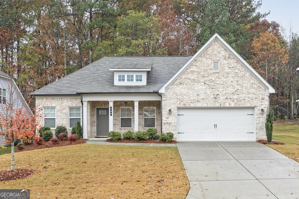 view of front of house featuring a front yard and a garage