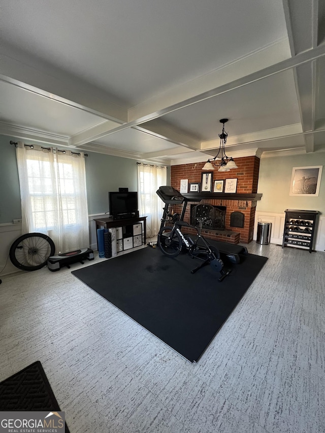 exercise room with carpet flooring, a fireplace, and coffered ceiling