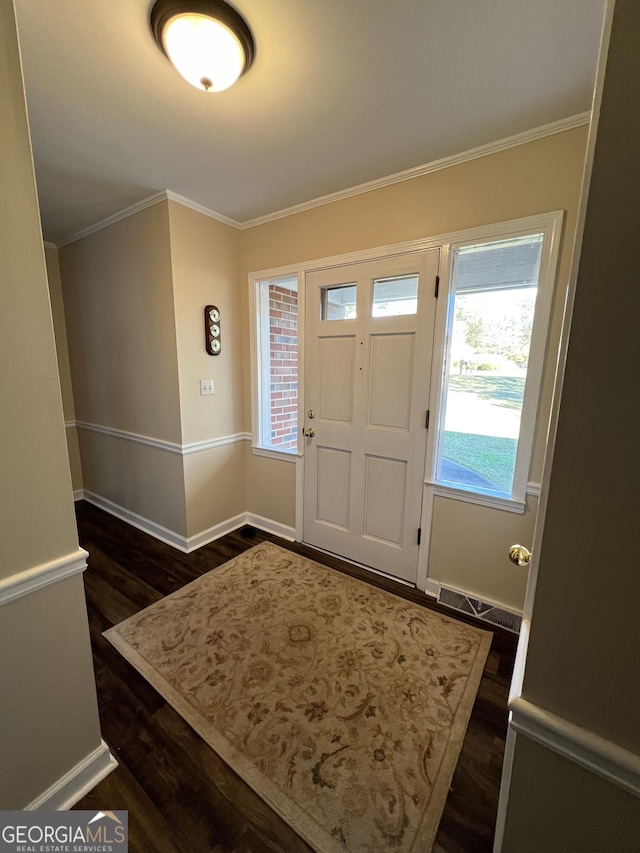 foyer featuring dark hardwood / wood-style floors and ornamental molding