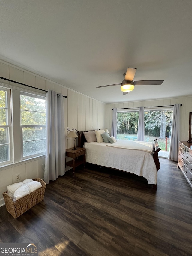 bedroom with ceiling fan and dark hardwood / wood-style flooring