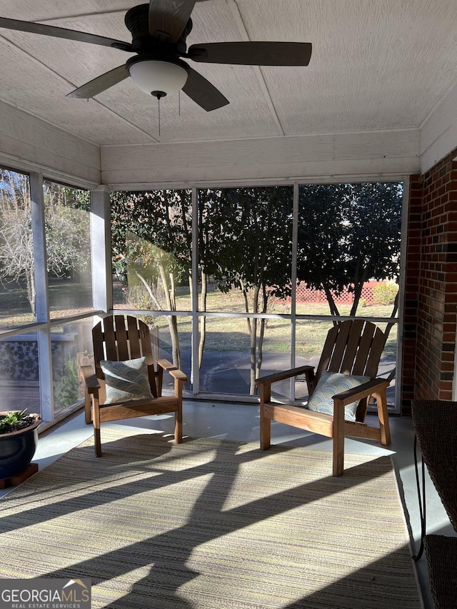 sunroom featuring ceiling fan