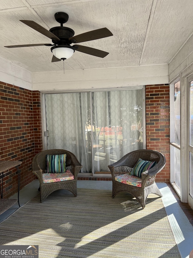 sunroom / solarium featuring ceiling fan