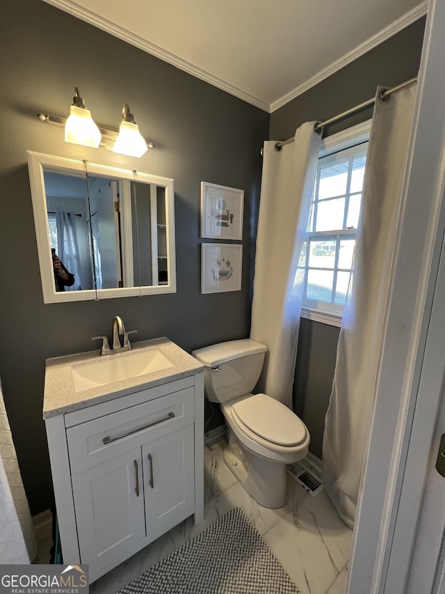 bathroom featuring vanity, toilet, and crown molding