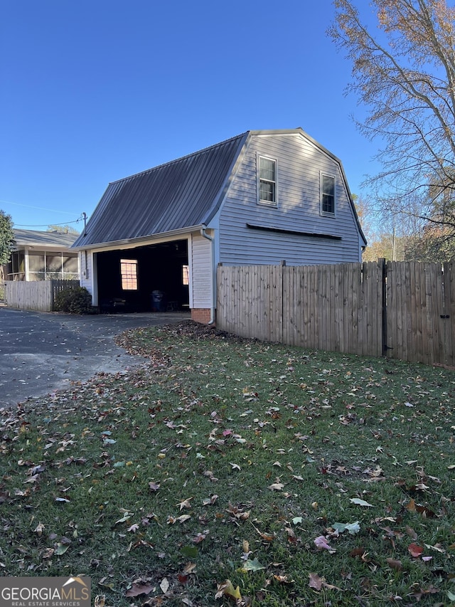 exterior space with a front yard, an outdoor structure, and a garage