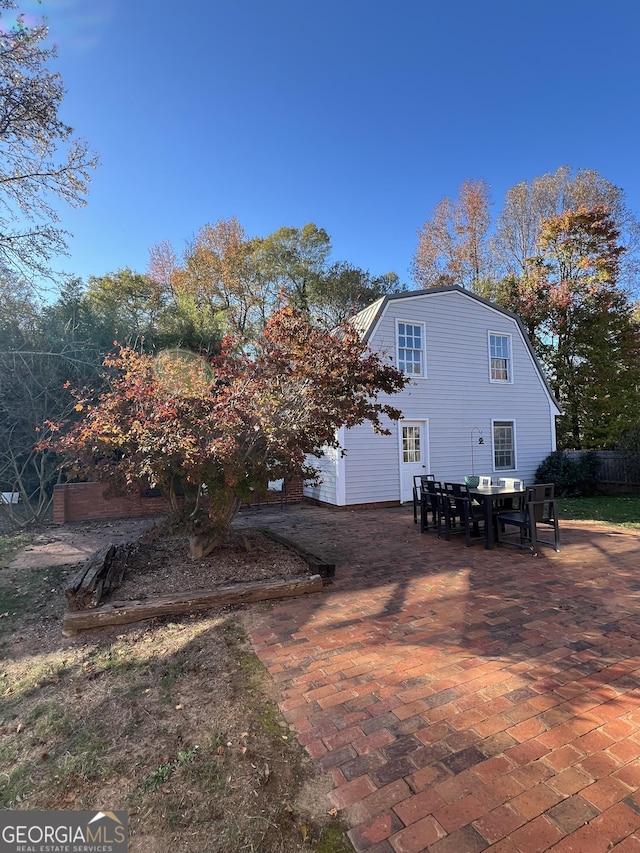 rear view of property featuring a patio