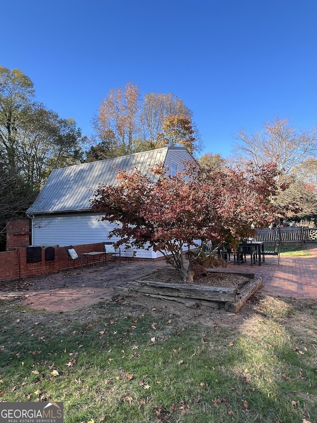 view of side of home featuring a patio area