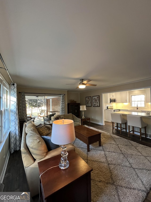 living room with dark hardwood / wood-style floors and ceiling fan