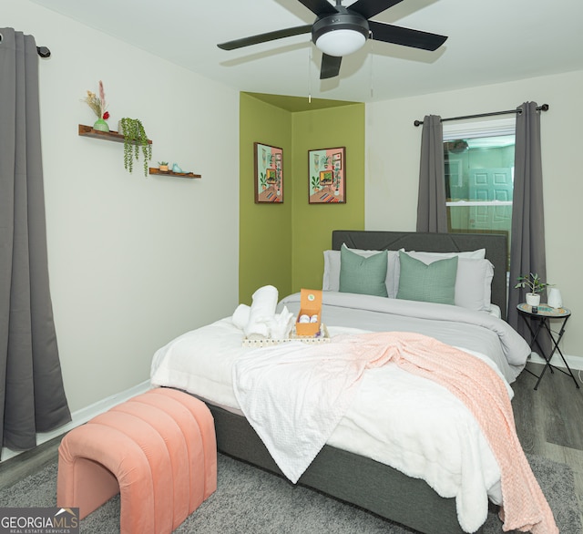 bedroom with hardwood / wood-style floors and ceiling fan