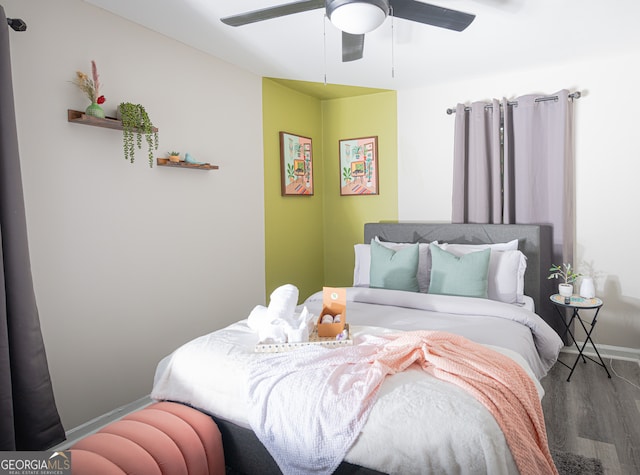 bedroom with hardwood / wood-style flooring and ceiling fan