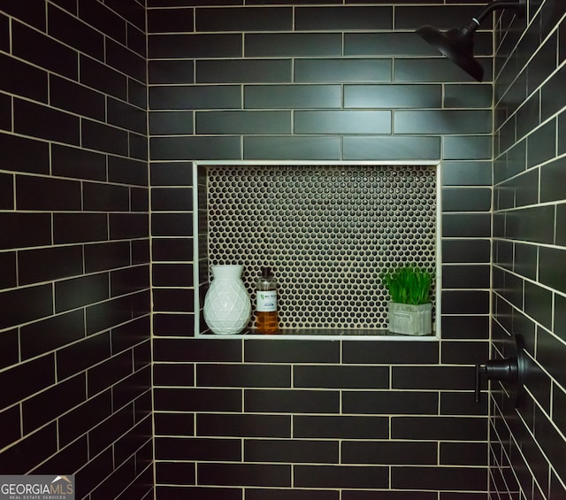 bathroom with a tile shower