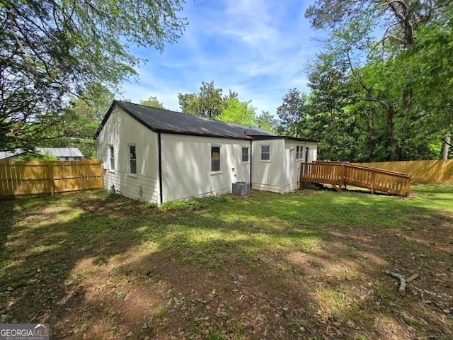 back of house with a yard and a deck