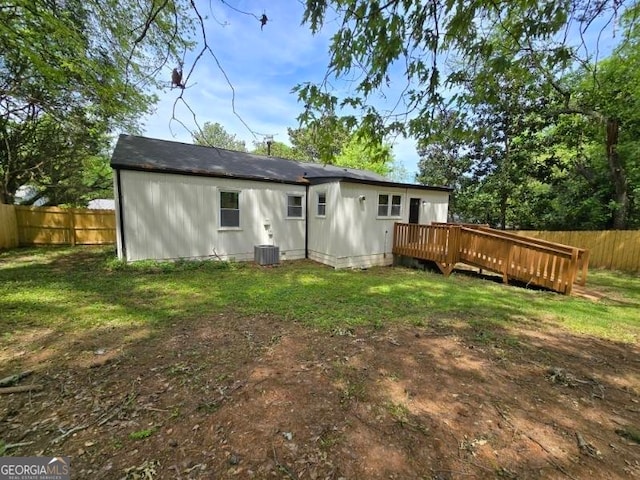 back of house with a wooden deck and a yard