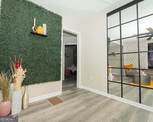 hall with hardwood / wood-style flooring