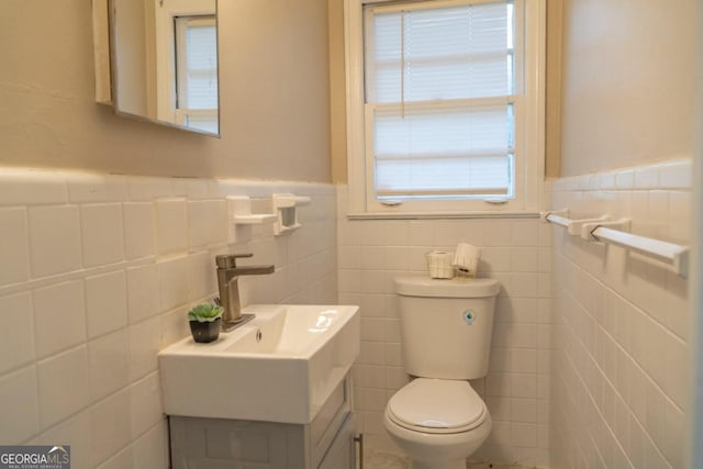 bathroom featuring toilet and tile walls