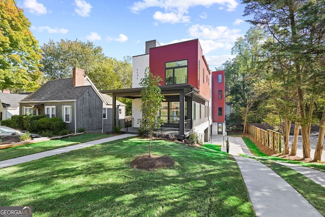 contemporary home with a front yard