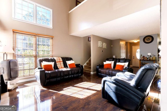 living room featuring hardwood / wood-style floors and a towering ceiling