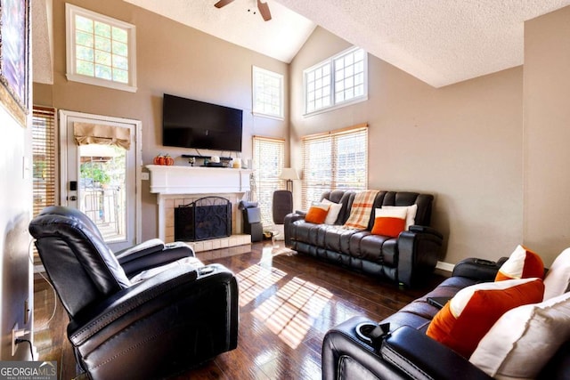 living room with plenty of natural light, dark hardwood / wood-style floors, and a textured ceiling