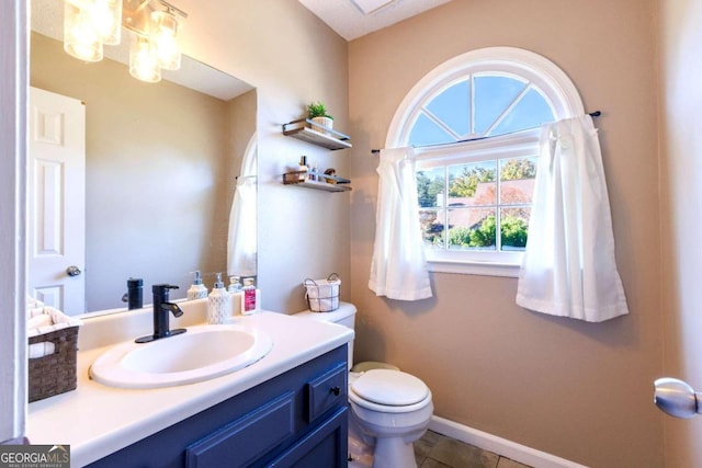 bathroom featuring tile patterned flooring, vanity, and toilet