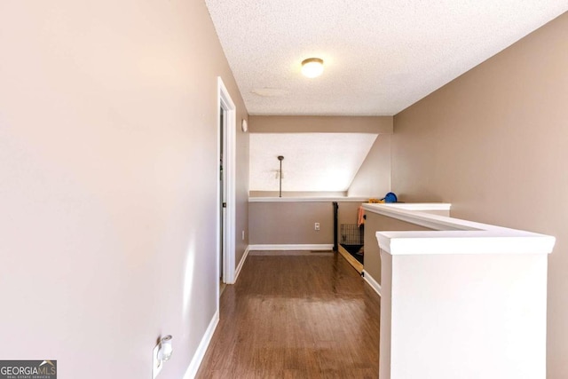 hallway featuring hardwood / wood-style floors and a textured ceiling