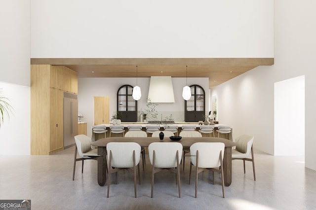 dining area with a chandelier and a towering ceiling