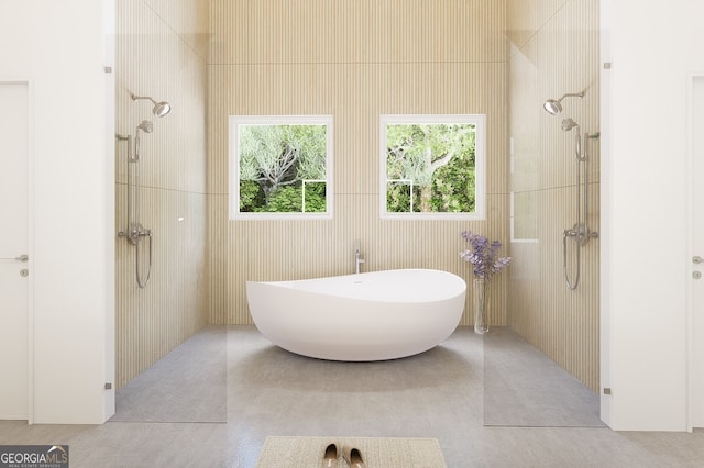 bathroom featuring tile patterned flooring, separate shower and tub, and tile walls