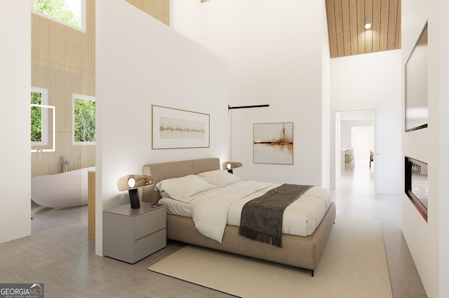 bedroom featuring a high ceiling and multiple windows